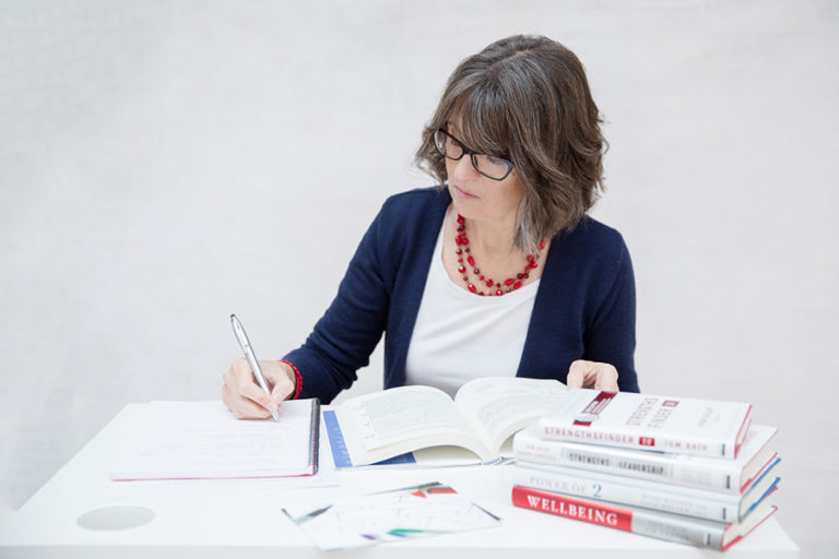 Charlotte Whitehead from Career Practic writing at her desk.